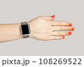 Closeup of woman hand with smartwatch with empty display handshaking with partner. Indoor studio shot isolated on gray background. 108269522