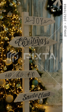 Wooden pole with arrow signs with New Year and Christmas inscriptions stock photo for vertical story Wooden pole with arrow signs with New Year and Christmas inscriptions stock photo for vertical story 108270468