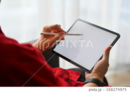 Cropped shot of man creative freelancer using stylus pen writing on digital tablet screen 108274975