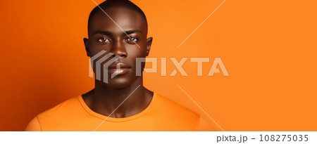 Portrait of a handsome elegant sexy African man with dark and perfect skin, on an orange background. Portrait of a handsome elegant sexy African man with dark and perfect skin, on an orange background. 108275035