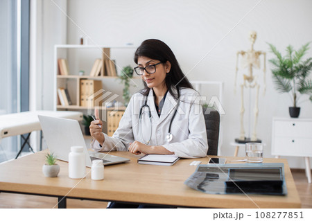 Doctor using laptop for video call with patient at hospital 108277851