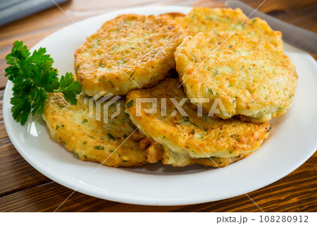 cooked fried potato cutlets with herbs 108280912