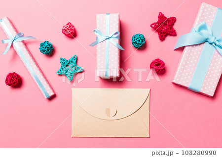 Top view of envelope on pink background. New Year decorations. Christmas holiday concept 108280990