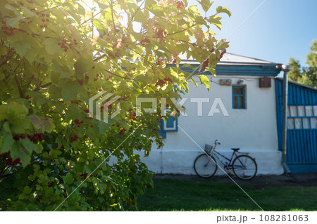 Bicycle leaning against village house wall 108281063