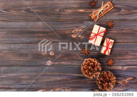 Natural Christmas Accessories Pine Cones Wooden Star Decorated Linen Cord Cinnamon Vintage Gifts on Wooden Background Natural Christmas Accessories Pine Cones Wooden Star Decorated Linen Cord Cinnamon Vintage Gifts on Wooden Background 108281068