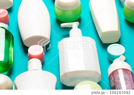 Top view of different cosmetic bottles and container for cosmetics on colored background. Flat lay composition with copy space Top view of different cosmetic bottles and container for cosmetics on colored background. Flat lay composition with copy space 108281092