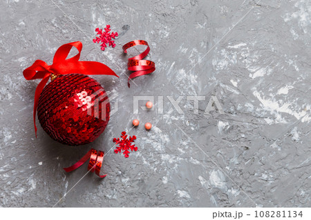Christmas ball on colored background. decoration bauble with ribbon bow with copy space 108281134