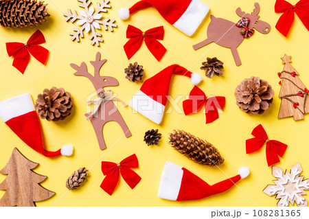 Christmas yellow background with holiday toys and decorations. Happy New Year concept Christmas yellow background with holiday toys and decorations. Happy New Year concept 108281365