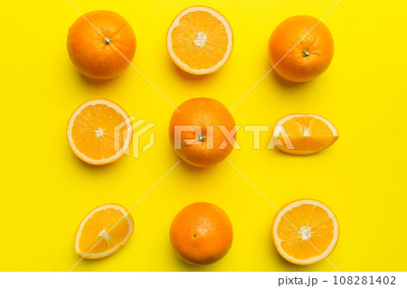 Fruit pattern of fresh orange slices on colored background. Top view. Copy Space. creative summer concept. Half of citrus in minimal flat lay 108281402