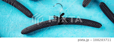 Fashion collection panorama. Black satin hangers for delicate clothes 108283711