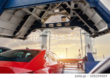 Front open door of passenger freight cargo ferry boat vessel ship with loaded cars and vehicles. Sea transportation ferryboat transport carrier unloading disembark. Northern Europe sea line 108284004