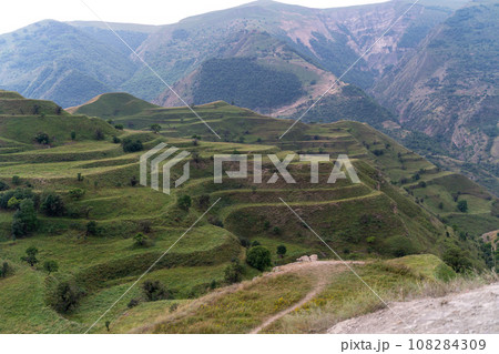 Chokhsky terraces Dagestan. Landscape of mountainous Dagestan with terraced fields and peaks mountains in the distance. Chokhsky terraces Dagestan. Landscape of mountainous Dagestan with terraced fields and peaks mountains in the distance. 108284309