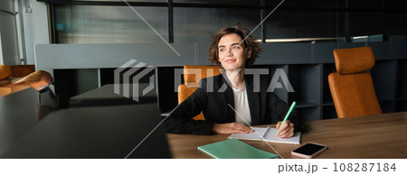 Portrait of saleswoman, ceo manager in office, working on project, writing down notes in documents 108287184