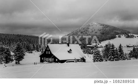 Jizerka Village and Bukovec Mounain in winter. Jizera Mountains, Czech Republic. Black and white image. 108288918
