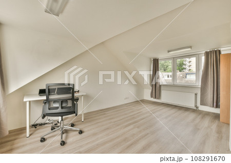 a room with wood flooring and an old tv on the wall in the corner of the room is empty 108291670