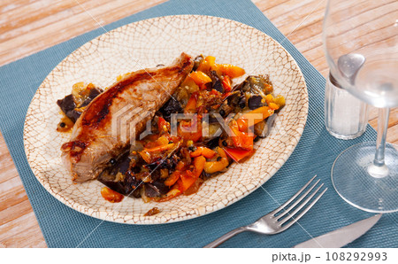 Roasted pork loin served with garnish of baked vegetables Roasted pork loin served with garnish of baked vegetables 108292993