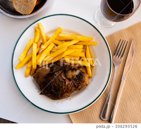 Roasted pork cheeks served with crispy french fries Roasted pork cheeks served with crispy french fries 108293526