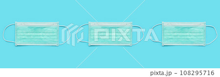 Surgical face mask on blue background protection against COVID-19 coronavirus. Healthcare and medical concept Surgical face mask on blue background protection against COVID-19 coronavirus. Healthcare and medical concept 108295716