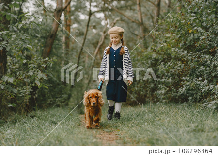 Friends are having fun in the fresh air. Child in a blue dress. 108296864