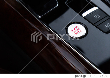 Start stop engine button Interior of modern luxury car. Details of automatic transmission gear shift, multimedia control system, car control panel, Air Vent Red emergency button and dashboard inside 108297309