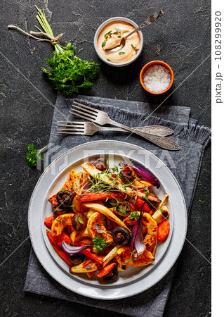 baked winter veggies and mushrooms on a plate 108299920