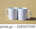 A white mug placed on a log with a view of nature in the background. 108307300
