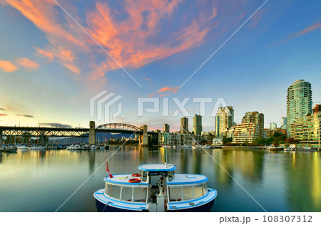 Ferry boat docked along in Granville island near Burrard Street Bridge at twilight in Vancouver,Canada 108307312