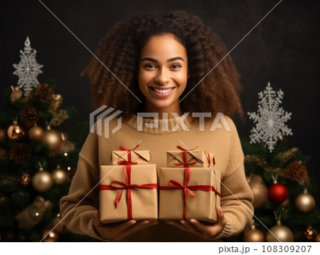 Portrait of a cheerful African American woman holding a gift. Boxing Day and Black Friday and holidays concept. 108309207