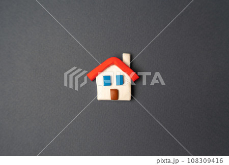 Small house on a gray background. Design and architectural services. Property insurance. Real estate market review. Construction industry. Buying and selling housing. 108309416
