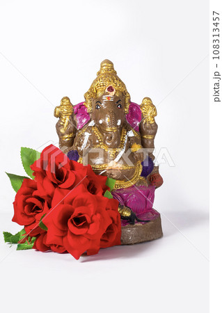 Ganesh statue made of clay is also a rose flower on white background. 108313457
