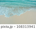 Soft wave of blue ocean on sandy beach. Summer vacation in island. clear azure water Background. 108313941