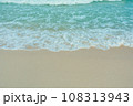 Soft wave of blue ocean on sandy beach. Summer vacation in island. clear azure water Background. 108313943