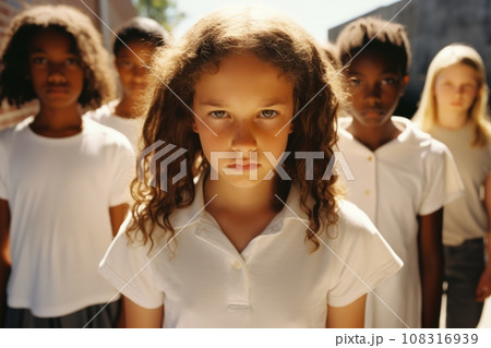 Multiethnic group of schoolchildren with their leader looking at camera with an angry and frustrated expression. Kids are upset and intending to stand up for their rights. Diversity and communication. Multiethnic group of schoolchildren with their leader looking at camera with an angry and frustrated expression. Kids are upset and intending to stand up for their rights. Diversity and communication. 108316939