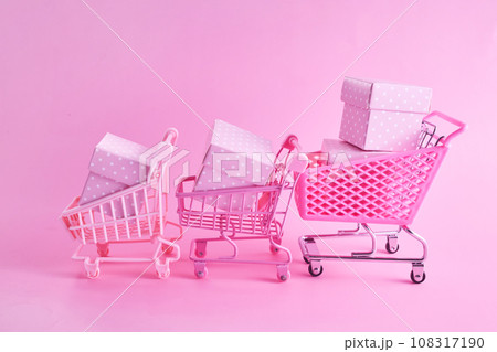 Pink friday concept. Online shopping.. Full shopping cart with presents. Pink friday concept. Online shopping.. Full shopping cart with presents. 108317190