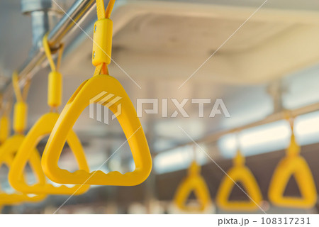 Handles on ceiling for standing passenger inside a bus Handles on ceiling for standing passenger inside a bus 108317231
