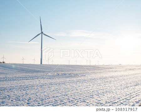 Wind turbines and agricultural field on winter day. Wind turbines and agricultural field on winter day. 108317917