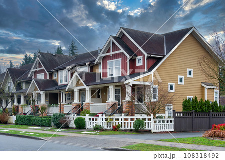 Street of residential townhouses on stormy sky background 108318492