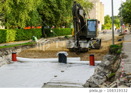 Use of geotextile fabric rolls for drainage and separation of base layers in street reconstruction 108319332