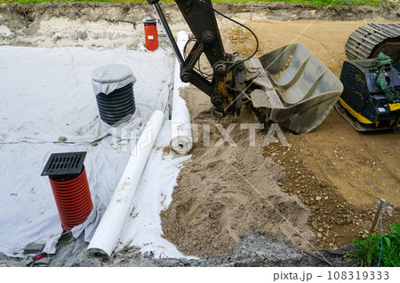 Use of geotextile fabric rolls for drainage and separation of base layers in street reconstruction Use of geotextile fabric rolls for drainage and separation of base layers in street reconstruction 108319333