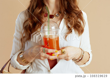 Stylish female in blouse and shorts isolated on beige Stylish female in blouse and shorts isolated on beige 108319619