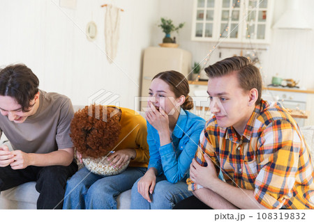 Group of friends watching sport match soccer football game on tv. Happy football fans celebrating victory at home. Friendship sports entertainment concept. Diverse buddies having fun together at home Group of friends watching sport match soccer football game on tv. Happy football fans celebrating victory at home. Friendship sports entertainment concept. Diverse buddies having fun together at home 108319832