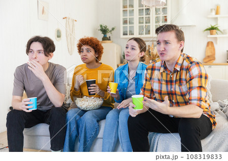 Group of friends watching sport match soccer football game on tv at home. Football fans disappointed missing goal loosing game. Friendship sports entertainment. Buddies watching championship together 108319833