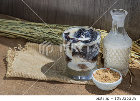 A Glass of Fresh milk grass jelly Dessert herbal gelatin or Jelly black with milk and brown sugar. A Glass of Fresh milk grass jelly Dessert herbal gelatin or Jelly black with milk and brown sugar. 108325238