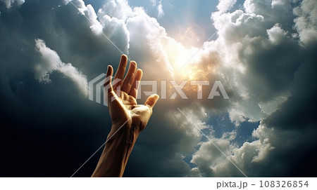 A man's hand reaches for the light in the clouds A man's hand reaches for the light in the clouds 108326854