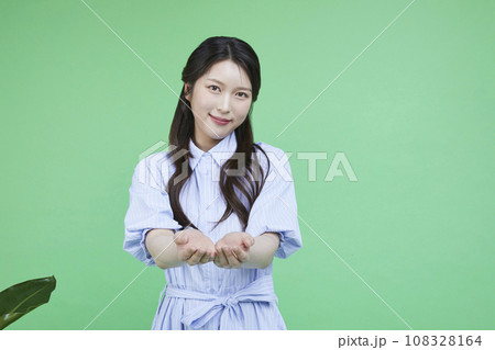 Green consumer_korean asain beautiful woman holding up her hands in introduction image Green consumer_korean asain beautiful woman holding up her hands in introduction image 108328164