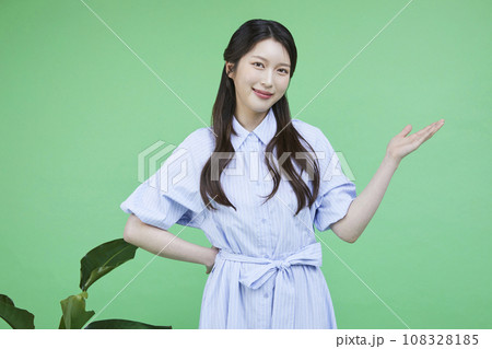 Green consumer_Image of a korean asain beautiful woman with hands gesturing to introduce herself Green consumer_Image of a korean asain beautiful woman with hands gesturing to introduce herself 108328185