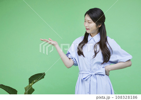 Green consumer_Image of a korean asain beautiful woman with hands gesturing to introduce herself 108328186