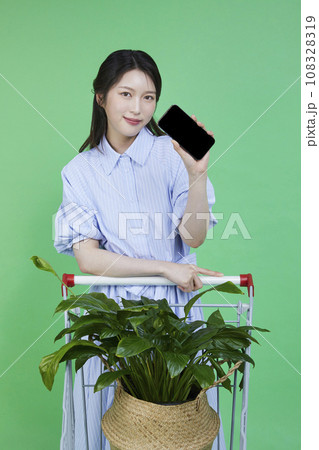 Greensumer_Shopping card with potted plants Image of a korean asain beautiful woman holding a smartphone. 108328319