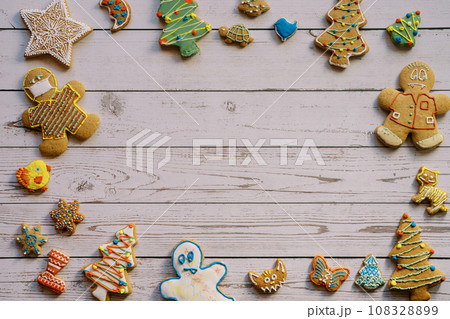 Ornament of colorful glazed Christmas cookies on a light wooden background 108328899