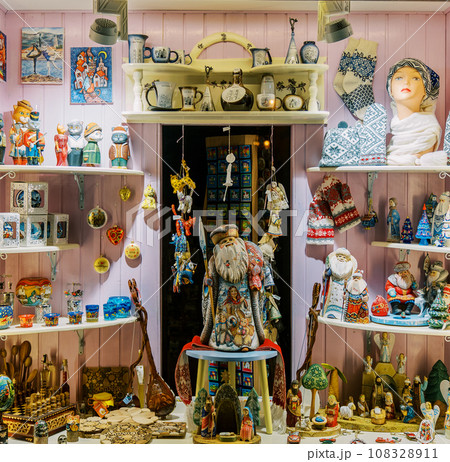 Colorful figurine of St. Nicholas among toys and souvenirs in the store 108328911